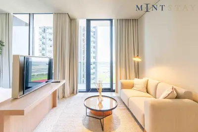 a living room with a couch and a tv at Upside Living, Business Bay Dubai - Mint Stay in Dubai