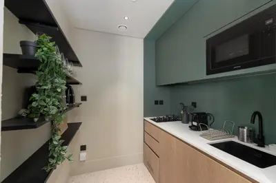 a kitchen with a sink and a counter with a plant at Upside Living, Burj Khalifa View, Business Bay - Mint Stay in Dubai