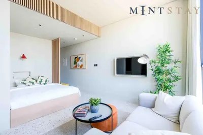 a hotel room with a bed and a couch at Upside Living, Burj Khalifa View, Business Bay - Mint Stay in Dubai