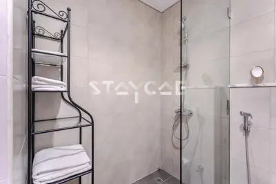 a shower with a glass door in a bathroom at Aykon City Staycae Holiday Homes, Business Bay, Sheikh Zayed Road in Dubai