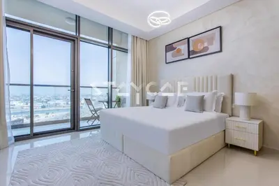 a bedroom with a large white bed and large windows at Aykon City Staycae Holiday Homes, Business Bay, Sheikh Zayed Road in Dubai