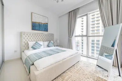 a bedroom with a bed and a large window at Modern 1BR Oasis in Beach Isle with Beach Access in Dubai