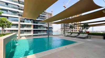 a swimming pool on the roof of a building at Modern 1BR Oasis in Beach Isle with Beach Access in Dubai