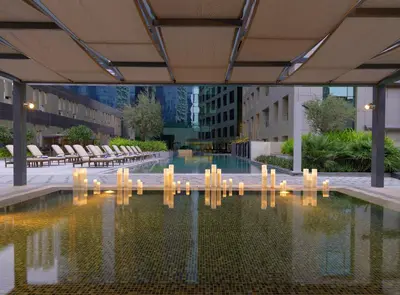 a pool of water with candles in a building at DAMAC Maison Cour Jardin in Dubai