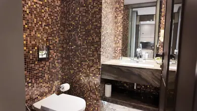 a bathroom with a toilet and a sink at Damac Heights by Fendi in Dubai