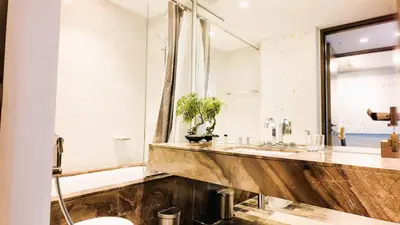 a bathroom with two sinks and a mirror at Damac Heights by Fendi in Dubai