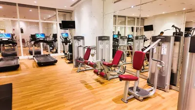 a gym with treadmills and exercise equipment in a building at Damac Heights by Fendi in Dubai