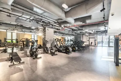 a gym with treadmills and elliptical machines at The Smart Concierge - La Rive Port De Lamer in Dubai