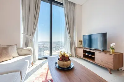 a living room with a television and large windows at 1BR Apartment at The Address JBR - Residential in Dubai