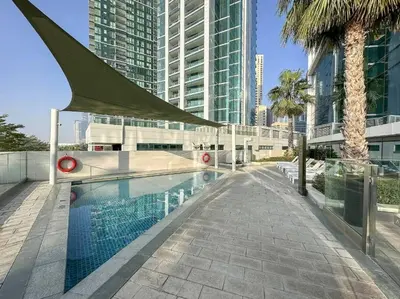 a swimming pool in a city with tall buildings at 1BR Apartment at The Address JBR - Residential in Dubai