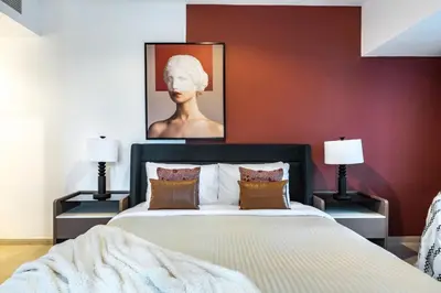 a bedroom with a large bed with two lamps at The Smart Concierge - Elite residence in Dubai