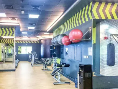 a gym with boxing equipment and balls on the wall at The Smart Concierge - Elite residence in Dubai