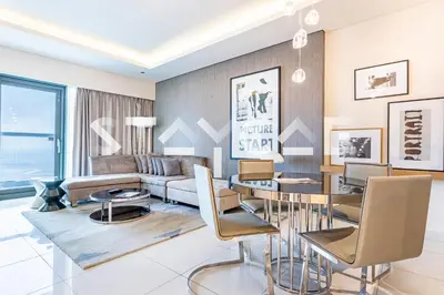 a living room with a couch and a table at Staycae Holiday Homes - Damac Towers By Paramount in Dubai