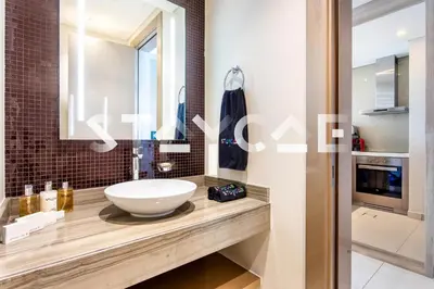 a bathroom with a sink and a mirror at Staycae Holiday Homes - Damac Towers By Paramount in Dubai