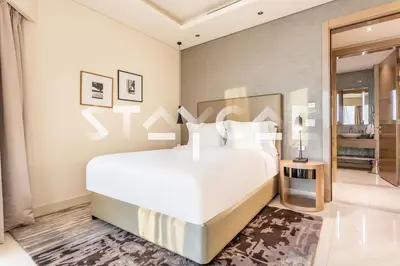 a bedroom with a large white bed in a room at Staycae Holiday Homes - Damac Towers By Paramount in Dubai