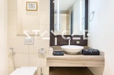 a bathroom with a sink and a mirror at Staycae Holiday Homes - Damac Towers By Paramount in Dubai