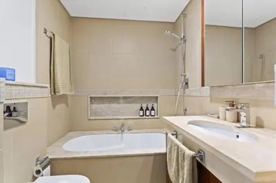 a bathroom with two sinks and a tub at Khalifa Views & Direct Mall Access in Burj Vista in Dubai