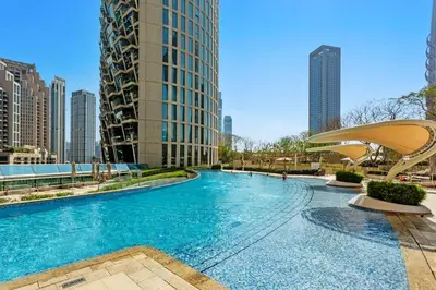 a large swimming pool in a city with tall buildings at Khalifa Views & Direct Mall Access in Burj Vista in Dubai