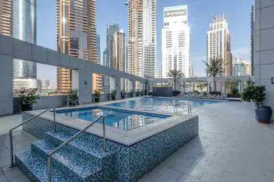 a swimming pool in the middle of a city with tall buildings at Marina & Beach Views, Pool, Art Haven! Near Cafes in Dubai