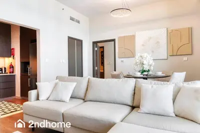 a living room with a white couch and a table at 2ndHome - Downtown Views 1 - Downtown Dubai in Dubai