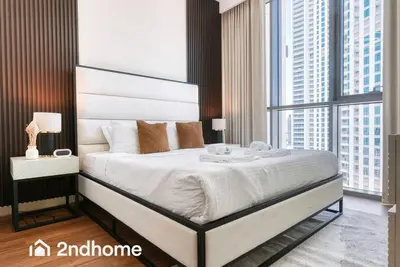 a bedroom with a large bed and a large window at 2ndHome - Downtown Views 1 - Downtown Dubai in Dubai