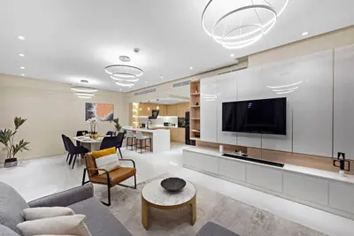 a living room with a couch and a tv at FIRST CLASS 2BR Incredible Burj Khalifa View in Dubai