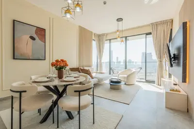 a living room with a table and chairs at Every Sunset is a Masterpiece in Catch Residence in Dubai