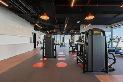 a gym with treadmills and elliptical machines at Every Sunset is a Masterpiece in Catch Residence in Dubai
