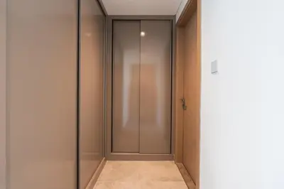 a walk in closet with a glass door at Every Sunset is a Masterpiece in Catch Residence in Dubai
