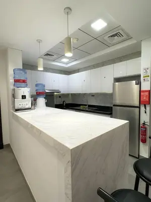 a large kitchen with a large white counter top at Hostel with Private Room near Downtown Business Bay in Dubai