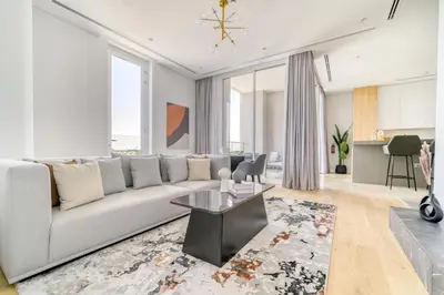 a living room with a couch and a table at Stella Stays Al-Barari in Dubai
