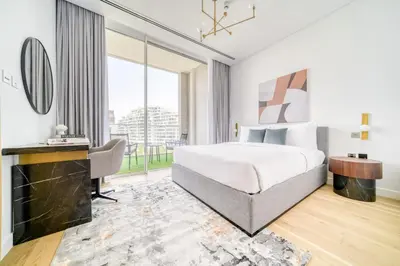 a hotel room with a bed and a desk at Stella Stays Al-Barari in Dubai