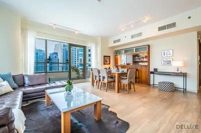 a living room with a couch and a table at Beautiful 2BR apartment in Al Sahab 2, Dubai Marina by Deluxe Holiday Homes in Dubai