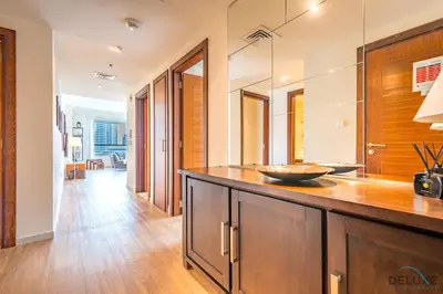 a kitchen with wooden cabinets and a counter top at Beautiful 2BR apartment in Al Sahab 2, Dubai Marina by Deluxe Holiday Homes in Dubai