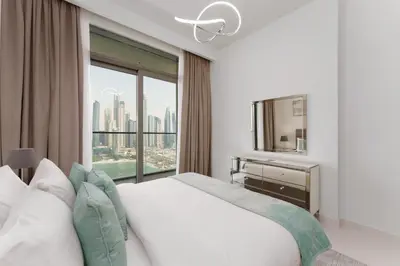 a bedroom with a white bed and a large window at Maison Privee - Exclusive Apt w/ Unmatched Dubai Marina Vistas in Dubai