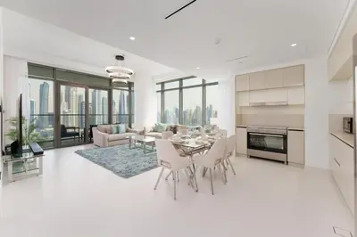 a kitchen and living room with a table and chairs at Maison Privee - Exclusive Apt w/ Unmatched Dubai Marina Vistas in Dubai
