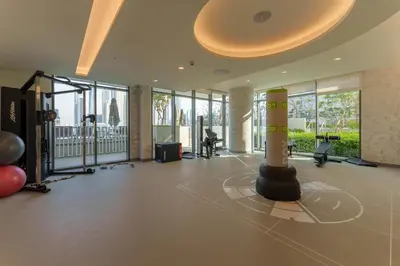 a gym with a pole in the middle of a room at Maison Privee - Exclusive Apt w/ Unmatched Dubai Marina Vistas in Dubai