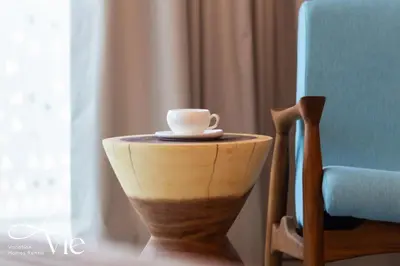 a cup sitting on a table next to a chair at La Vie, JBR in Dubai