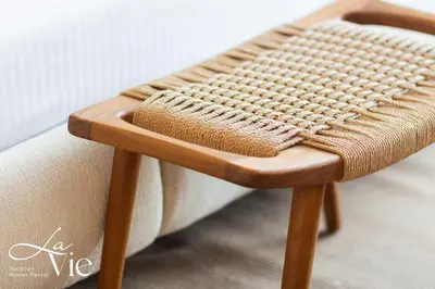 a wooden chair with a cushion on top of it at La Vie, JBR in Dubai