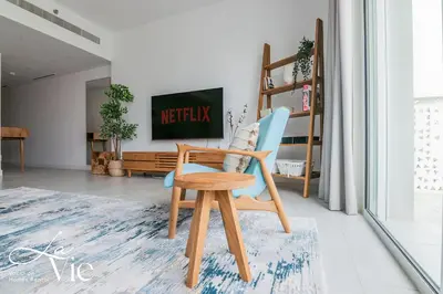 a wooden chair sitting in a living room at La Vie, JBR in Dubai