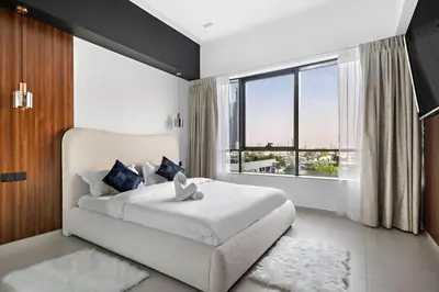 a bedroom with a white bed and a large window at Amazing 1br located in the heart of Dubai,JLT in Dubai