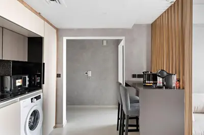 a kitchen with a washer and dryer in a room at Amazing 1br located in the heart of Dubai,JLT in Dubai