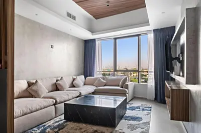a living room with a couch and a large window at Amazing 1br located in the heart of Dubai,JLT in Dubai