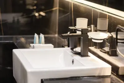a bathroom with a sink and toothbrushes at Fully Furnished Luxe 1BR In JVC in Dubai
