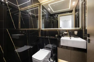 a bathroom with a sink and a toilet and a mirror at Fully Furnished Luxe 1BR In JVC in Dubai
