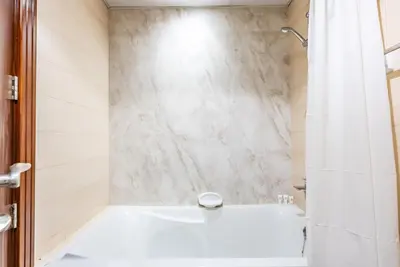 a bathroom with a white tub and a shower at Elite Vista Studio Elite 10 Sports Residences in Dubai