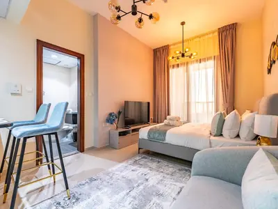 a hotel room with a bed and a tv at Elite Vista Studio Elite 10 Sports Residences in Dubai