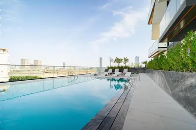 a swimming pool on the roof of a building at CitiHome - 1BR Freshly Styled and Comfortable in JVC in Dubai