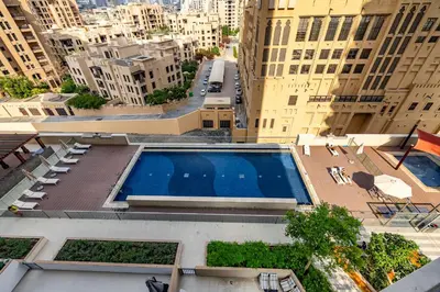 an overhead view of a building with a swimming pool at Apartment with Burj Khalifa View I Bellevue Tower in Dubai