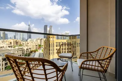 a balcony with two chairs and a view of a city at Apartment with Burj Khalifa View I Bellevue Tower in Dubai